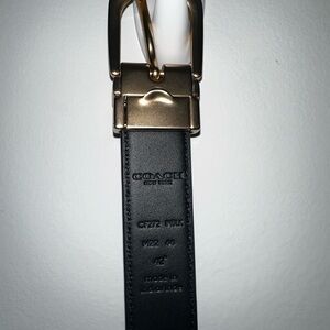 Golds and black leather coach belt 42”